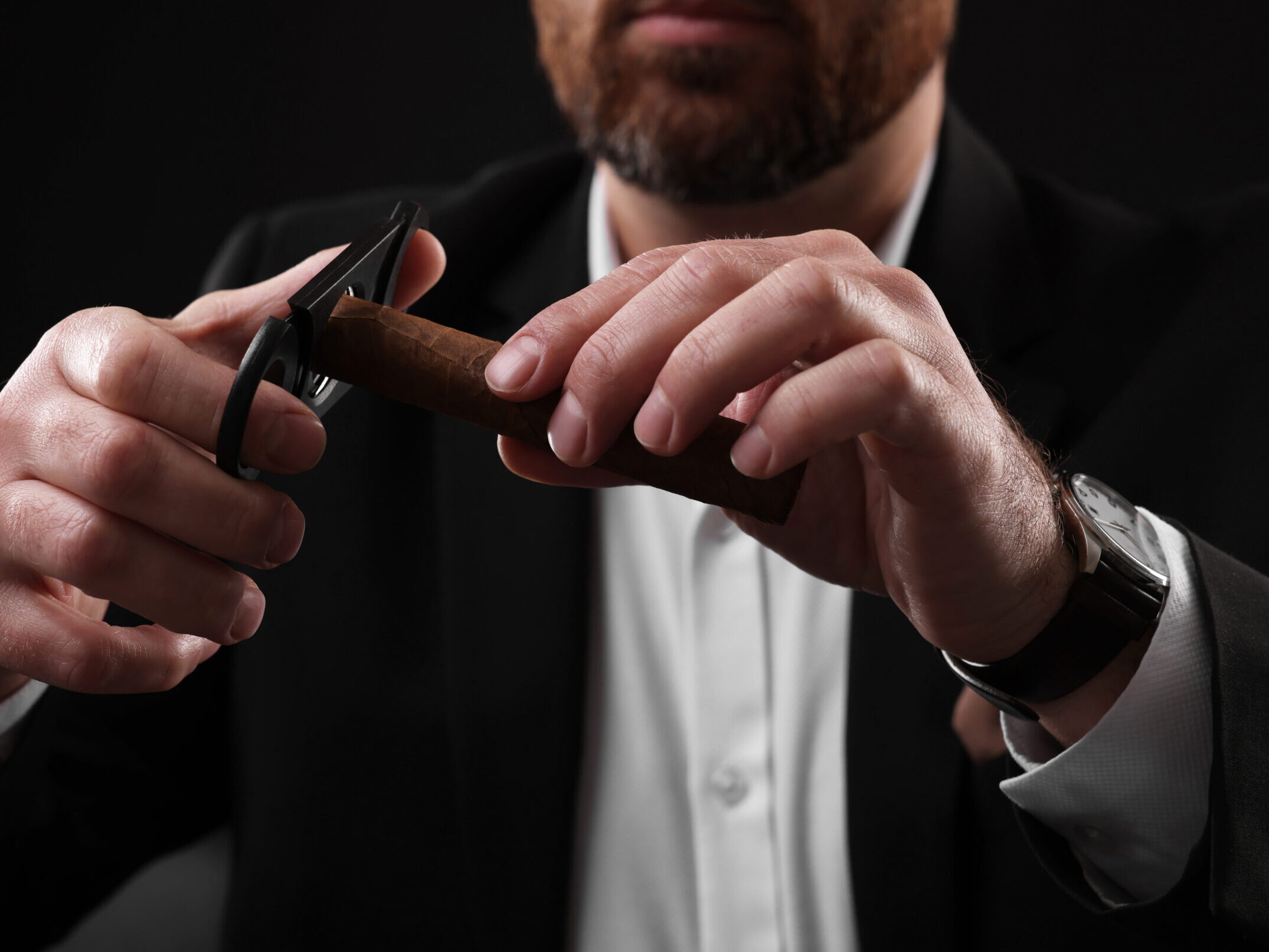 Butler cutting tip of cigar